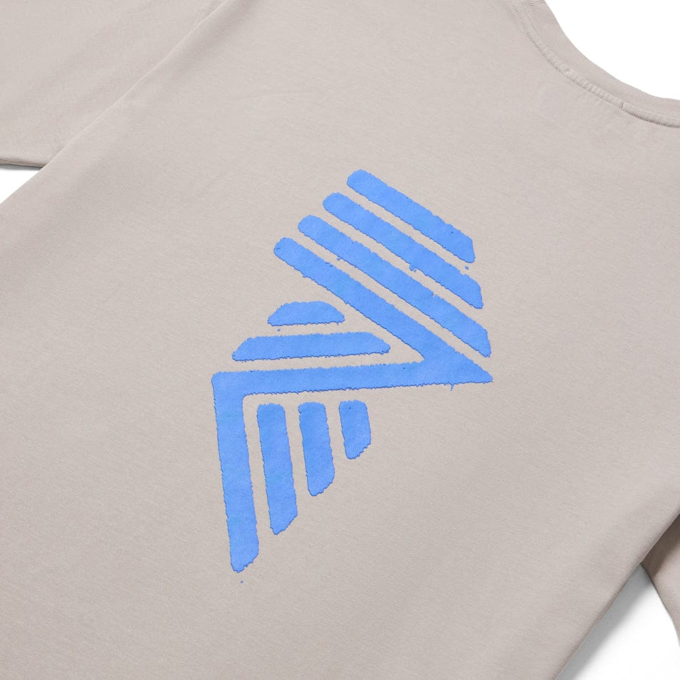 Beige shirt with blue geometric design.