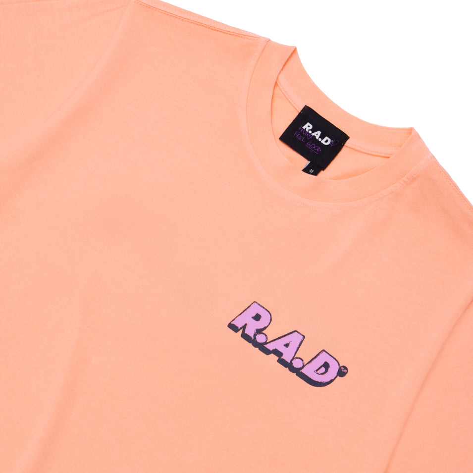 Peach-colored t-shirt.