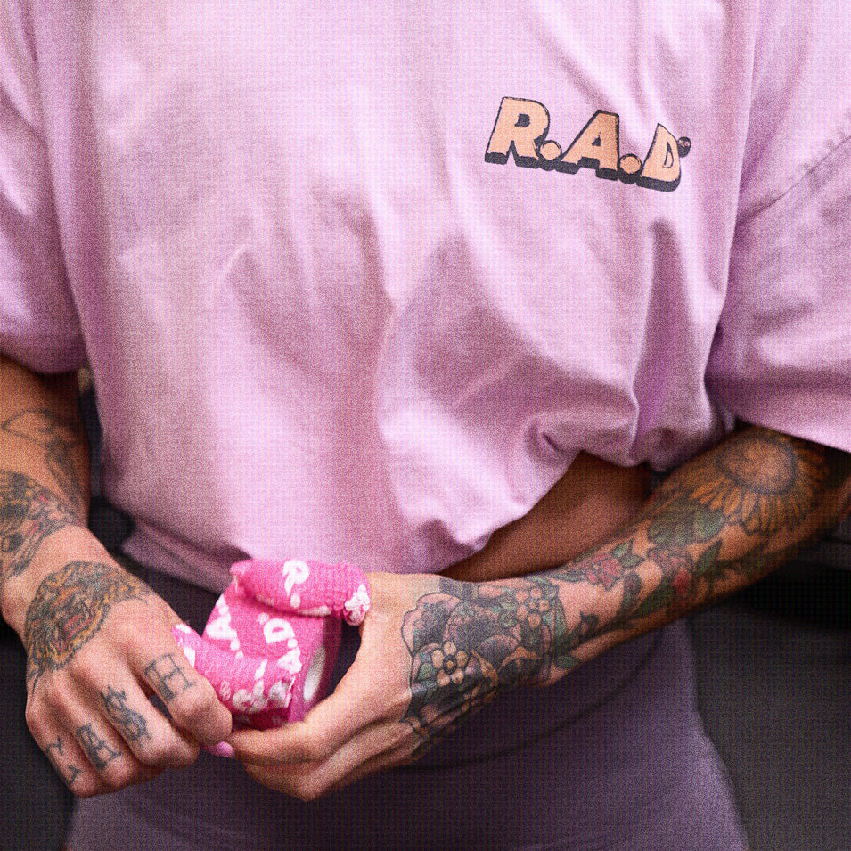Pink t-shirt with tattoos.