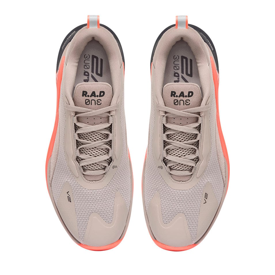 Pair of beige and orange running shoes.