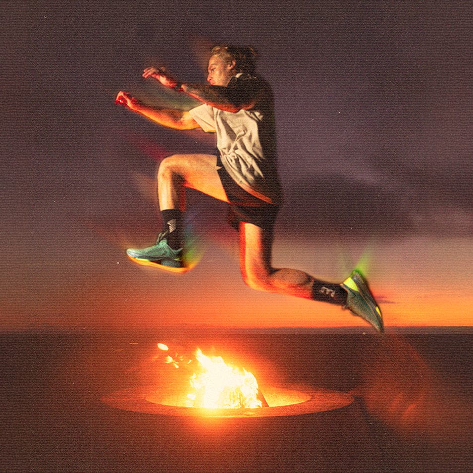 Person leaping over fire pit using R.A.D® R-1 GREEN FLASH outdoor product