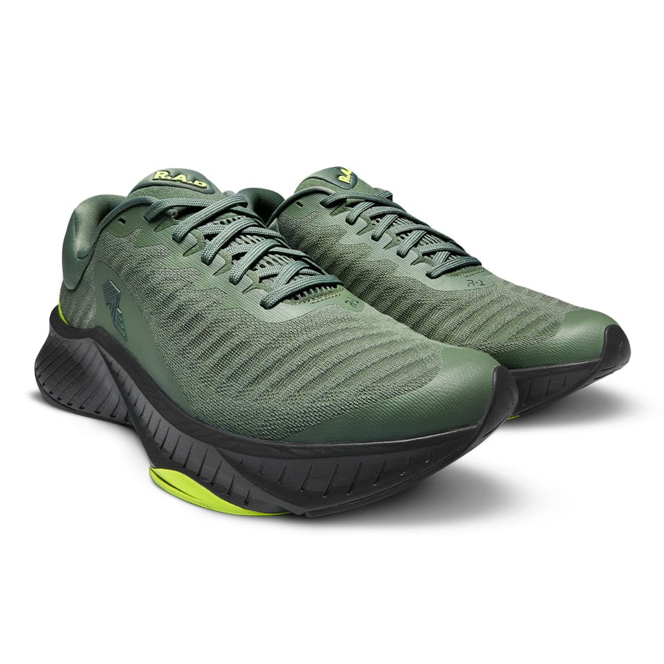 Green running shoes with black soles.