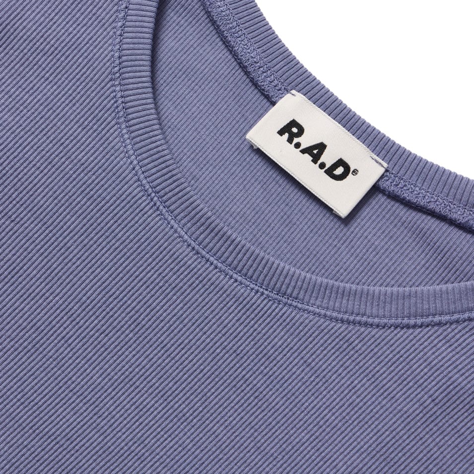 Periwinkle ribbed knit top with a brand label.