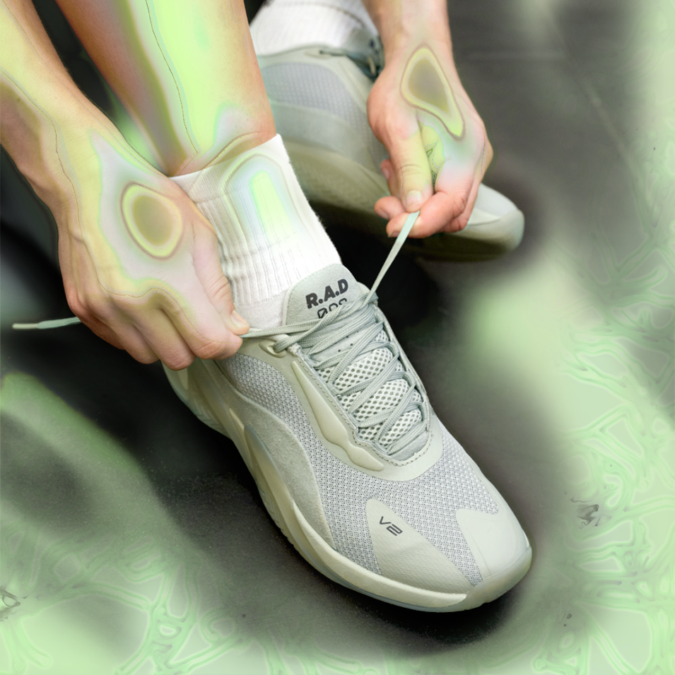 Gray athletic shoe being tied from R.A.D® ONE V2 DUST GREEN collection
