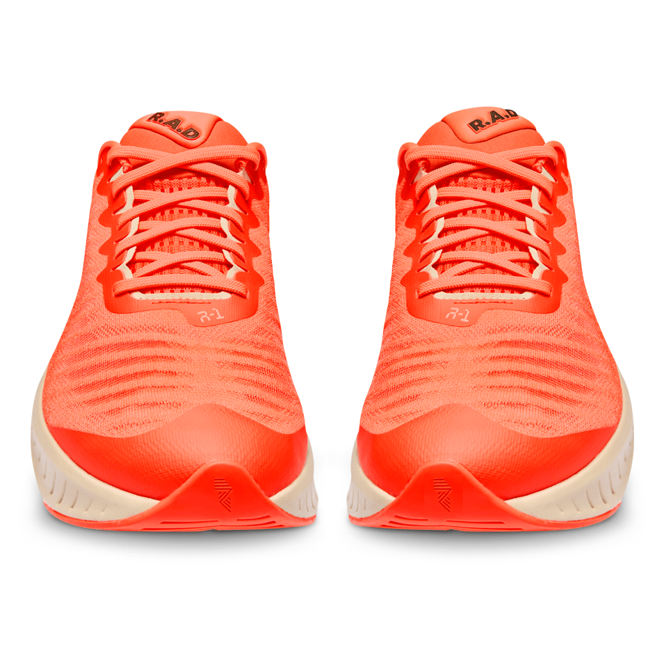 Pair of bright orange running shoes.