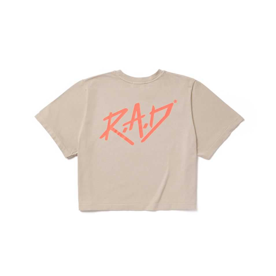 Beige crop top with pink ’RAD’ graphic.