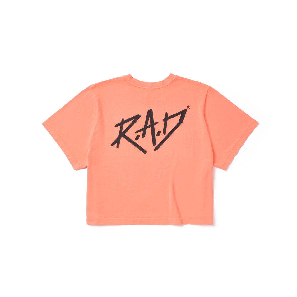 Peach-colored crop top with black lettering.