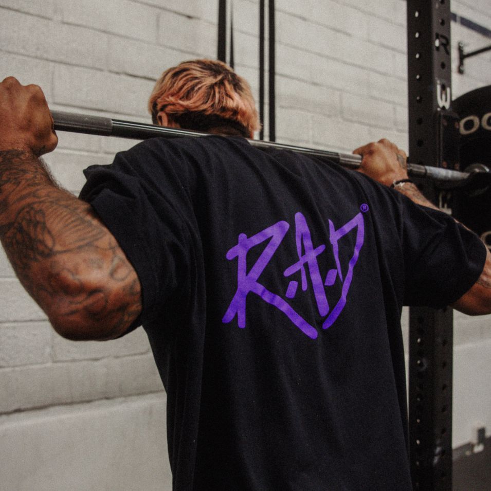 Black t-shirt with purple ’RAD’ logo.